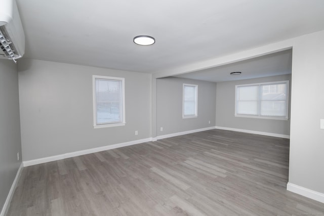 670 Putnam Pike, Rhode Island, RI 02828 - unfurnished room with wood finished floors, baseboards, and a wall mounted air conditioner