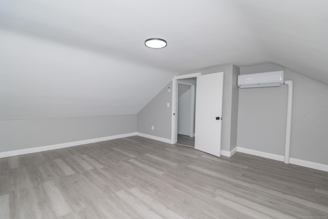 670 Putnam Pike, Rhode Island, RI 02828 - additional living space featuring a wall mounted air conditioner, vaulted ceiling, wood finished floors, and baseboards