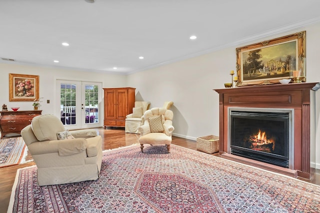27 E Gate Rd, Danbury, CT 06811 - living room with wood finished floors, french doors, a warm lit fireplace, crown molding, and recessed lighting