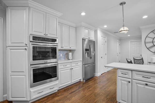 27 E Gate Rd, Danbury, CT 06811 - kitchen with stainless steel appliances, crown molding, recessed lighting, light countertops, and dark wood-style floors