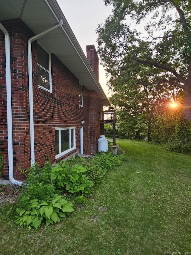36 View St, Plainville, CT 06062 - view of side of property with a chimney, brick siding, and a yard