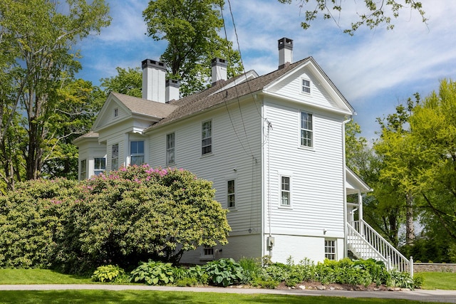 118 S St, Litchfield, CT 06759 - view of side of home featuring a chimney, stairway, and a yard
