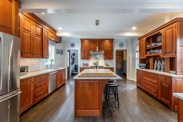 118 S St, Litchfield, CT 06759 - kitchen with stainless steel appliances, under cabinet range hood, a sink, light countertops, and a kitchen island