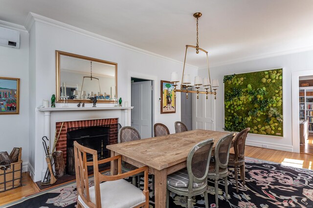 118 S St, Litchfield, CT 06759 - dining area featuring ornamental molding, wood finished floors, a brick fireplace, and a chandelier