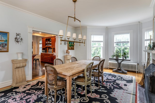 118 S St, Litchfield, CT 06759 - dining space featuring radiator heating unit, healthy amount of natural light, crown molding, wood finished floors, and a chandelier