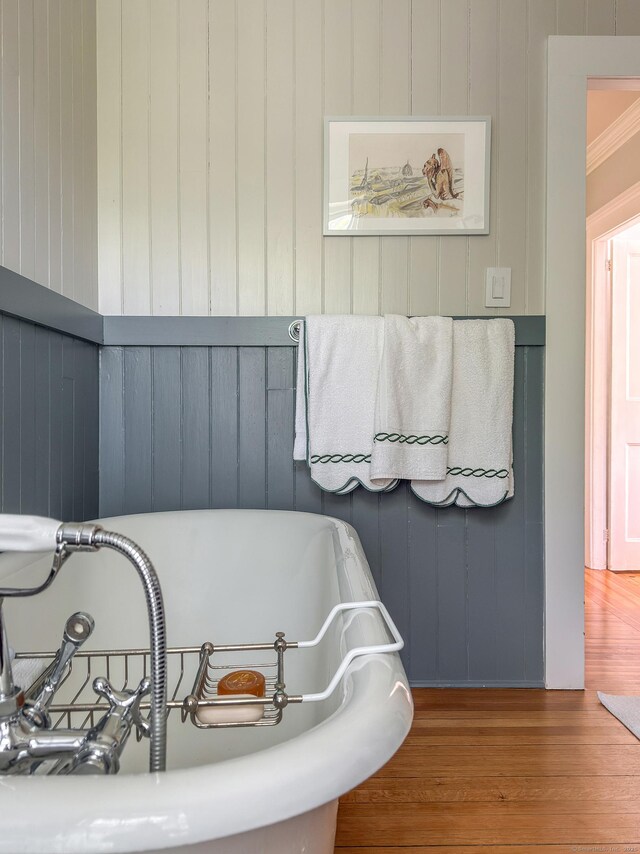 118 S St, Litchfield, CT 06759 - bathroom featuring a freestanding tub, wood finished floors, and wood walls