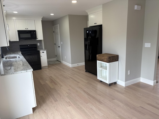 19 Race Ave, Plainville, CT 06062 - kitchen featuring black appliances, baseboards, a sink, white cabinets, and recessed lighting
