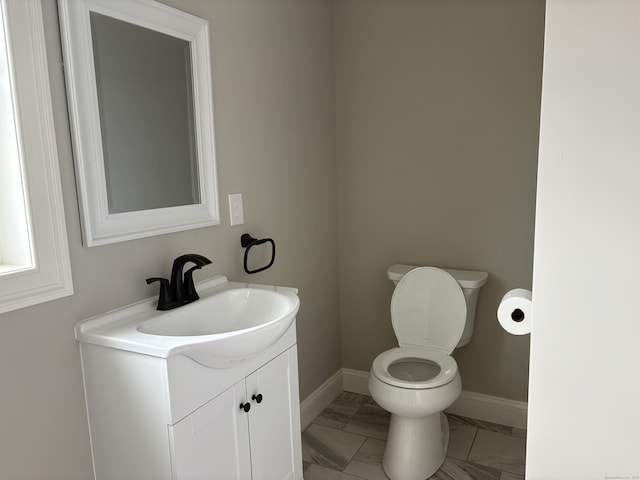 19 Race Ave, Plainville, CT 06062 - bathroom featuring vanity, toilet, baseboards, and marble look tile flooring