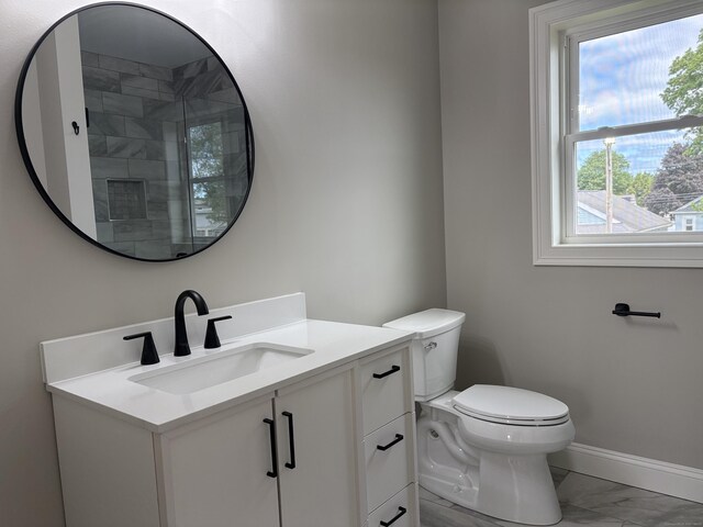 19 Race Ave, Plainville, CT 06062 - bathroom featuring marble look tiles, vanity, toilet, and baseboards