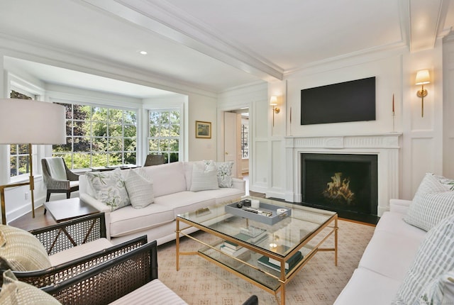 42 Morningside Dr S, Westport, CT 06880 - living area with ornamental molding, a fireplace with flush hearth, a decorative wall, and wood finished floors