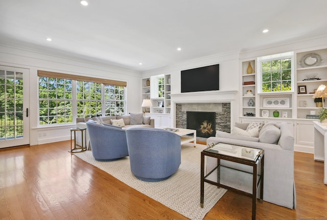 42 Morningside Dr S, Westport, CT 06880 - living room featuring ornamental molding, a fireplace, built in shelves, wood finished floors, and recessed lighting
