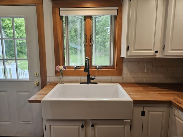 16 Walnut St (Pawcatuck), Unit Pawcatuck Stonington, CT 06379 - kitchen featuring butcher block countertops, white cabinetry, tasteful backsplash, and a sink