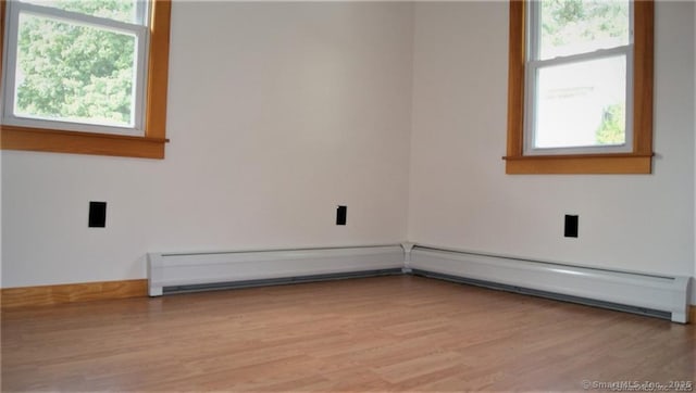 16 Walnut St (Pawcatuck), Unit Pawcatuck Stonington, CT 06379 - spare room featuring wood finished floors, plenty of natural light, and a baseboard radiator