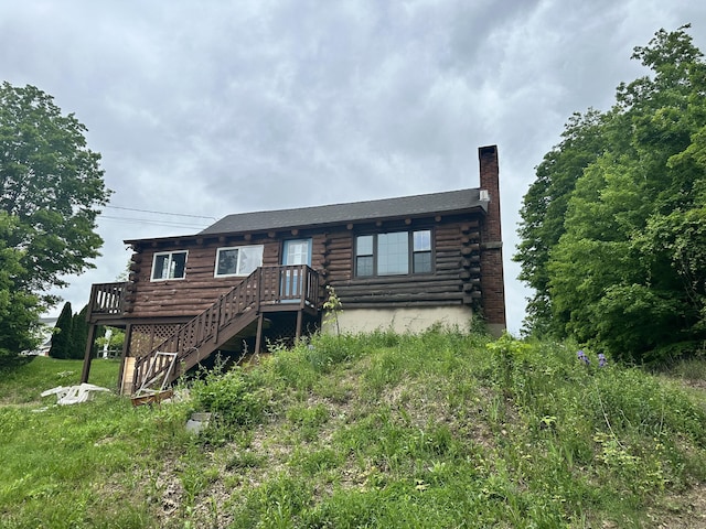 153 N Main St, East Granby, CT 06026 - log-style house with log exterior, a chimney, and a wooden deck