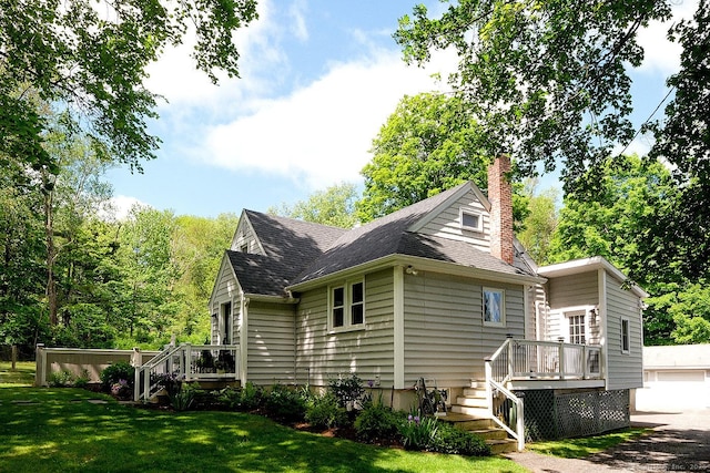21 Perry St, Salisbury, CT 06039 - view of side of home featuring a deck, a chimney, a lawn, roof with shingles, and a garage