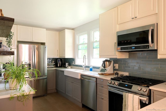 21 Perry St, Salisbury, CT 06039 - kitchen featuring stainless steel appliances, gray cabinetry, light countertops, decorative backsplash, and light wood-style flooring