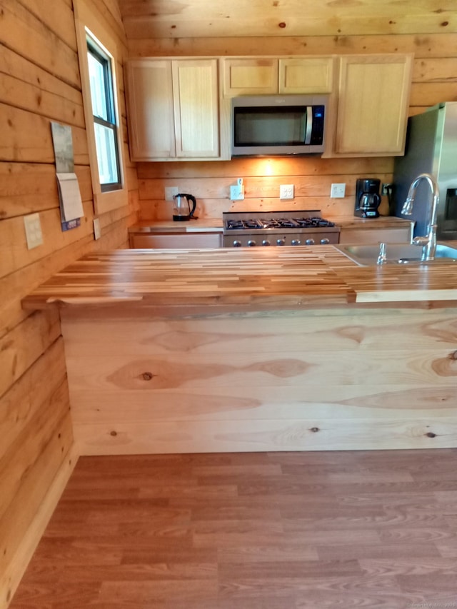 80 John Mack Rd, Hampton, CT 06247 - kitchen with appliances with stainless steel finishes, a sink, butcher block counters, wood finished floors, and wood walls