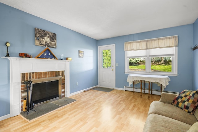 18 Kimberly Dr, Enfield, CT 06082 - living room with baseboard heating, wood finished floors, a brick fireplace, and baseboards