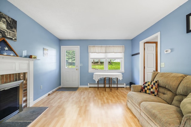 18 Kimberly Dr, Enfield, CT 06082 - living room featuring baseboard heating, wood finished floors, a brick fireplace, and baseboards