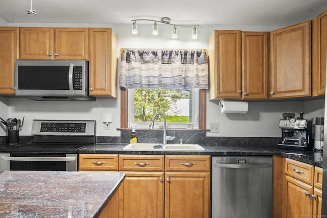 18 Kimberly Dr, Enfield, CT 06082 - kitchen with stainless steel appliances, a sink, brown cabinetry, and dark countertops