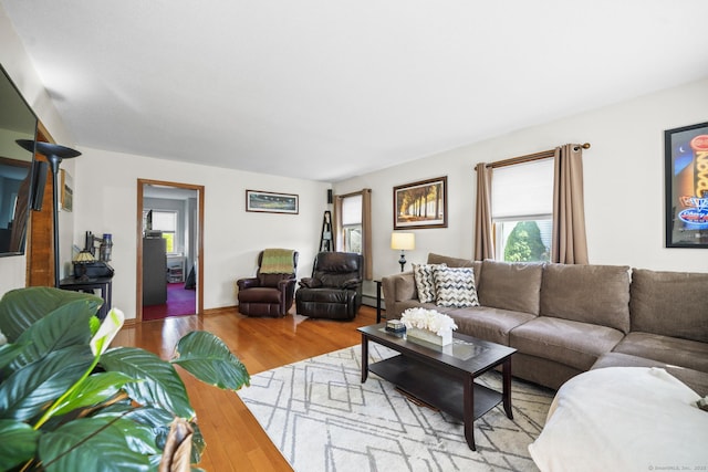 18 Kimberly Dr, Enfield, CT 06082 - living area featuring healthy amount of natural light, wood finished floors, and baseboard heating