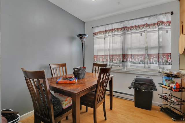 239 Glen St, New Britain, CT 06051 - dining space with a baseboard radiator, light wood-type flooring, and baseboards