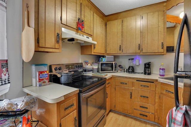 239 Glen St, New Britain, CT 06051 - kitchen featuring appliances with stainless steel finishes, under cabinet range hood, light countertops, light wood-style flooring, and a textured ceiling