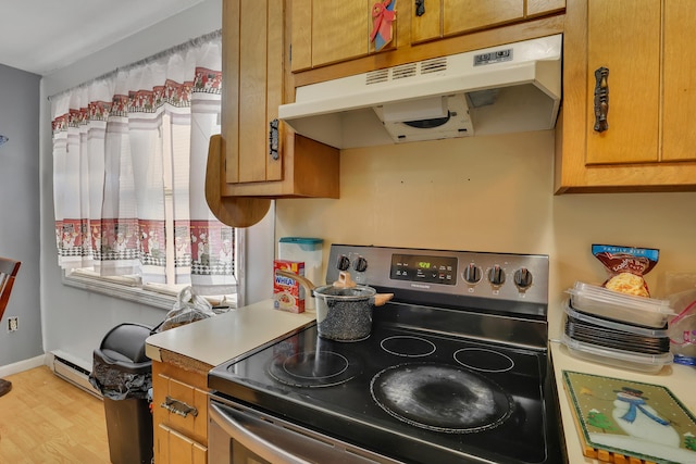 239 Glen St, New Britain, CT 06051 - kitchen with stainless steel electric range, under cabinet range hood, a baseboard heating unit, light wood-type flooring, and light countertops