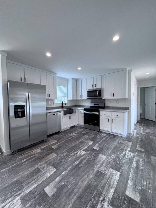 7 Middle Ter, Vernon, CT 06066 - kitchen featuring appliances with stainless steel finishes, a sink, dark wood finished floors, white cabinetry, and recessed lighting
