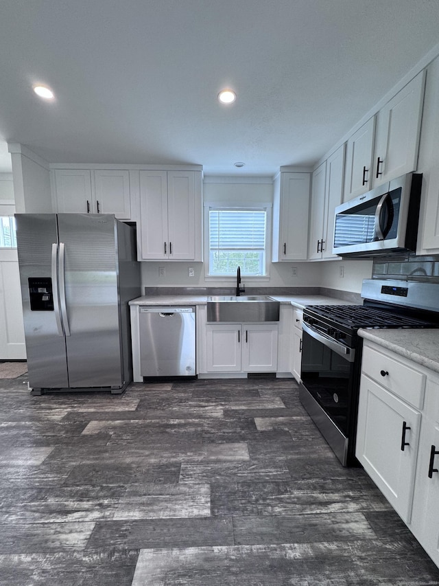 7 Middle Ter, Vernon, CT 06066 - kitchen with appliances with stainless steel finishes, a sink, white cabinetry, dark wood-style floors, and recessed lighting