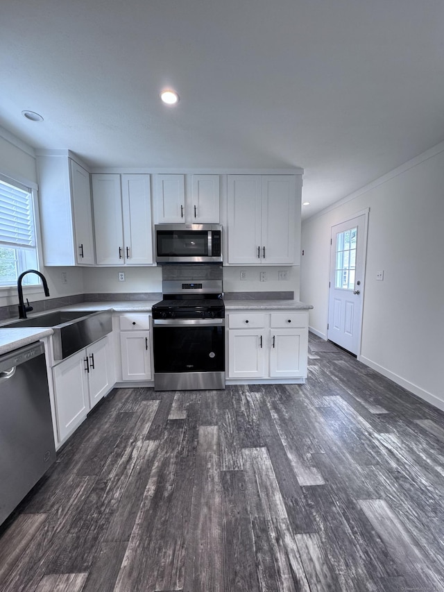 7 Middle Ter, Vernon, CT 06066 - kitchen featuring appliances with stainless steel finishes, dark wood-style floors, a sink, white cabinetry, and ornamental molding