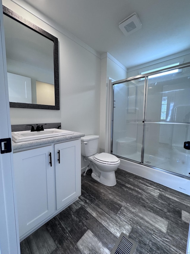 7 Middle Ter, Vernon, CT 06066 - bathroom featuring toilet, vanity, a shower with door, wood finished floors, and ornamental molding