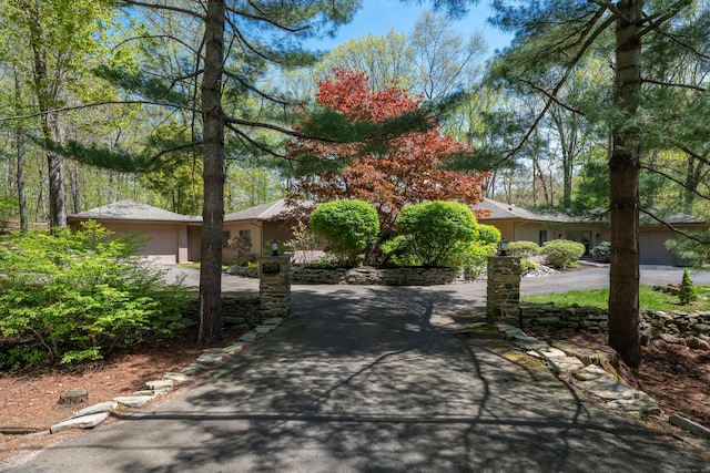 291 Peddlers Rd, Guilford, CT 06437 - view of front of house with driveway, an attached garage, and stucco siding