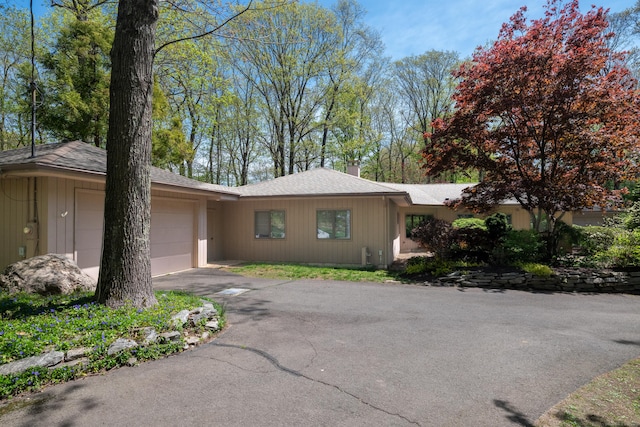 291 Peddlers Rd, Guilford, CT 06437 - view of front of home featuring an attached garage, driveway, roof with shingles, and a chimney