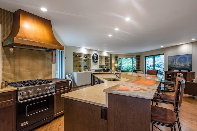 291 Peddlers Rd, Guilford, CT 06437 - kitchen with open floor plan, custom exhaust hood, luxury range, a breakfast bar, and recessed lighting