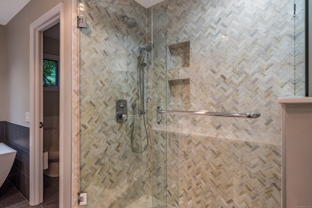291 Peddlers Rd, Guilford, CT 06437 - bathroom featuring a stall shower, tile walls, and toilet