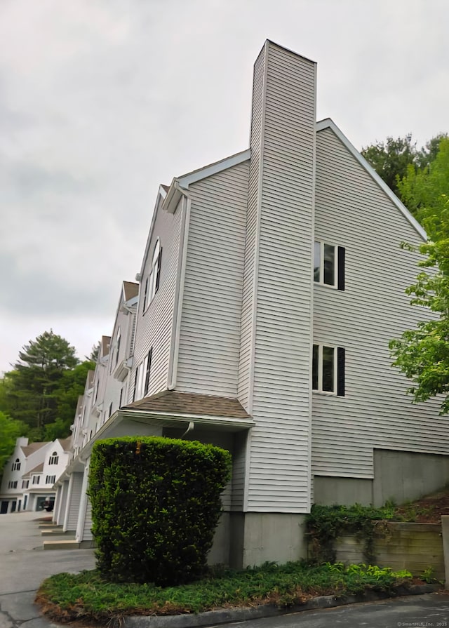 605 Whetstone Mls Unit 605, Killingly, CT 06241 - view of property exterior with a chimney