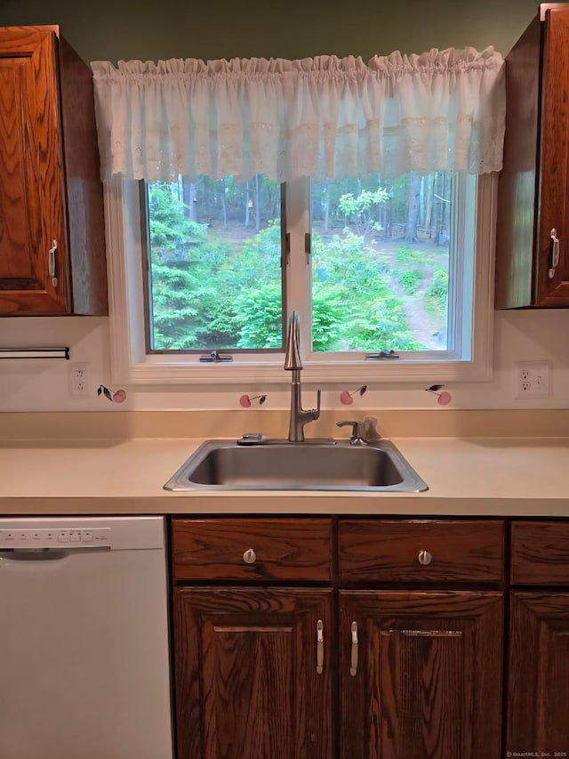 605 Whetstone Mls Unit 605, Killingly, CT 06241 - kitchen featuring white dishwasher, a sink, light countertops, and healthy amount of natural light