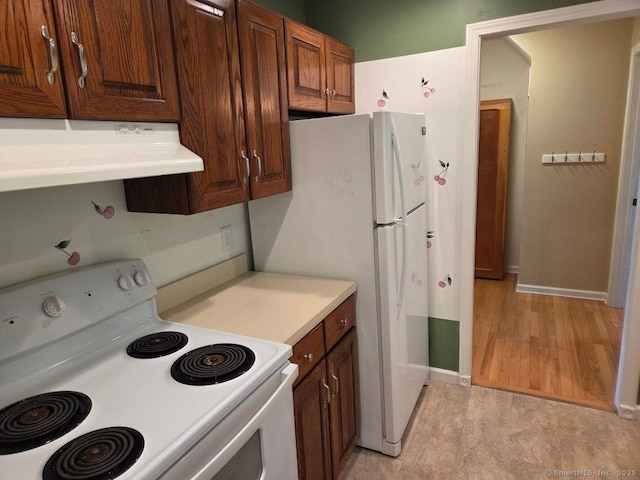 605 Whetstone Mls Unit 605, Killingly, CT 06241 - kitchen featuring white electric range, ventilation hood, baseboards, and light countertops
