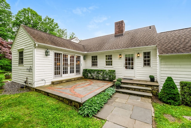 1208 Smith Ridge Rd, New Canaan, CT 06840 - rear view of property featuring a chimney, a shingled roof, and a patio area
