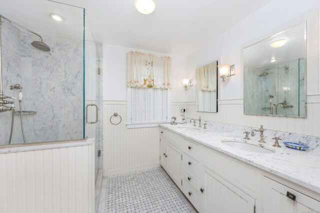 1208 Smith Ridge Rd, New Canaan, CT 06840 - full bath with a marble finish shower, wainscoting, double vanity, and tile patterned floors
