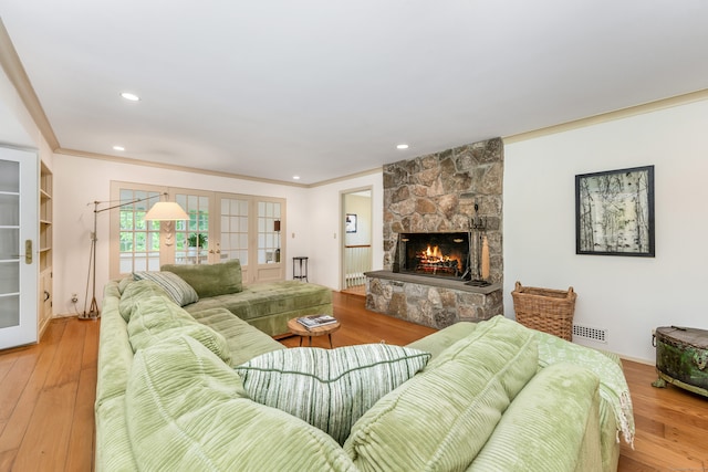 1208 Smith Ridge Rd, New Canaan, CT 06840 - living area featuring french doors, ornamental molding, a stone fireplace, wood finished floors, and recessed lighting