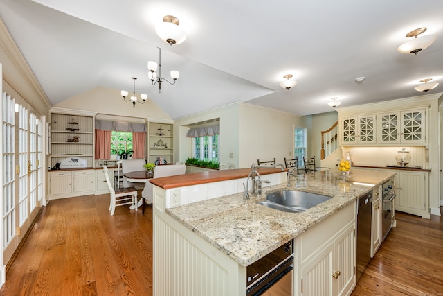 1208 Smith Ridge Rd, New Canaan, CT 06840 - kitchen featuring a spacious island, wood finished floors, a sink, appliances with stainless steel finishes, and light stone counters