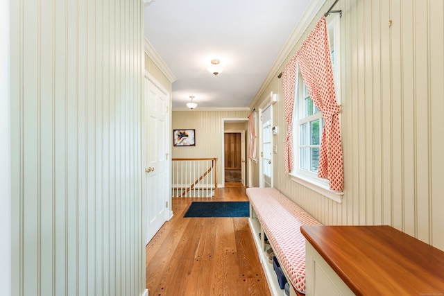 1208 Smith Ridge Rd, New Canaan, CT 06840 - hallway with light wood-type flooring, crown molding, an upstairs landing, and wallpapered walls