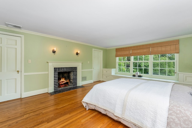 1208 Smith Ridge Rd, New Canaan, CT 06840 - bedroom with wood finished floors, ornamental molding, and a fireplace