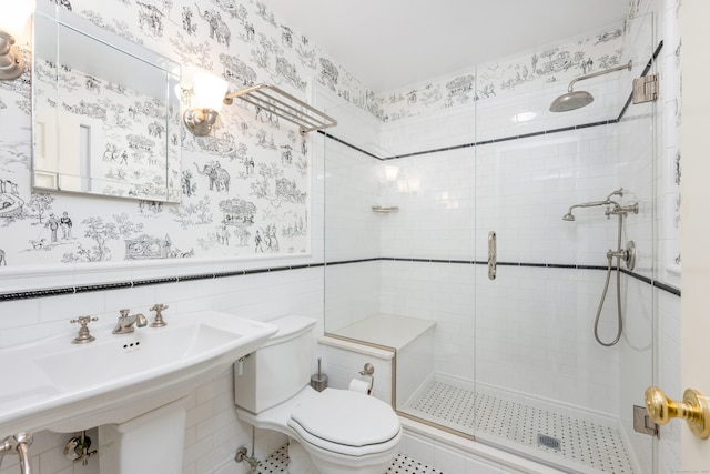 1208 Smith Ridge Rd, New Canaan, CT 06840 - full bathroom with toilet, a stall shower, wainscoting, wallpapered walls, and tile walls