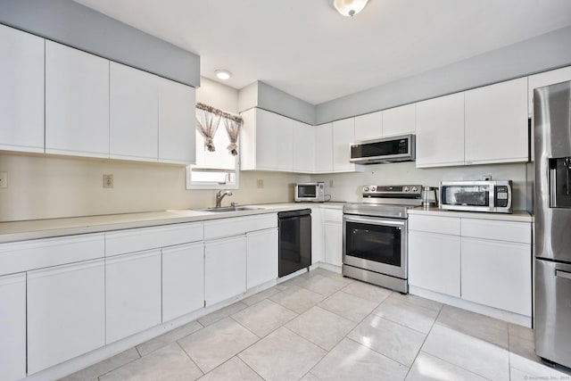 5 Stevens St, Bridgeport, CT 06606 - kitchen with appliances with stainless steel finishes, light countertops, a sink, and white cabinetry