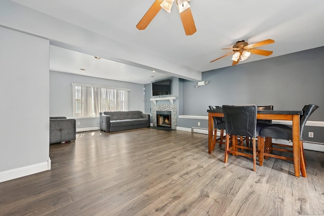 5 Stevens St, Bridgeport, CT 06606 - dining area with a ceiling fan, wood finished floors, a fireplace, baseboards, and baseboard heating