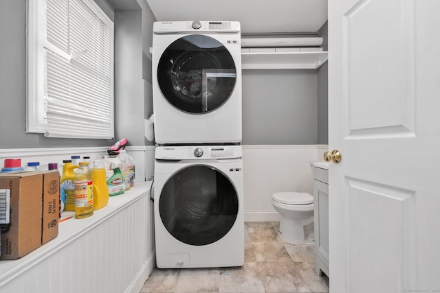 5 Stevens St, Bridgeport, CT 06606 - laundry room featuring stacked washer / dryer and a wainscoted wall