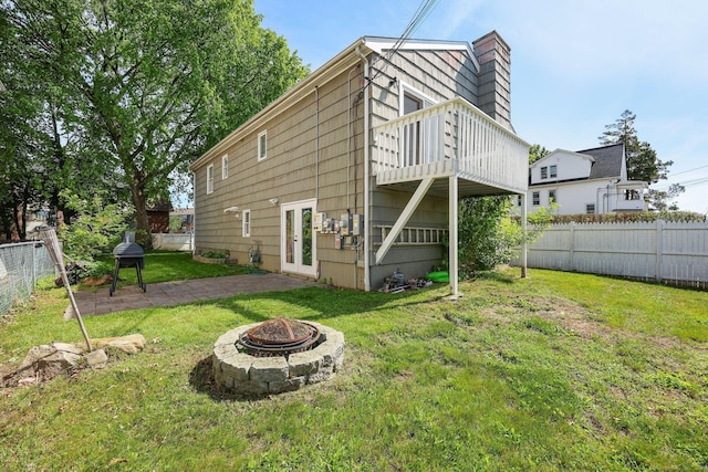 5 Stevens St, Bridgeport, CT 06606 - rear view of property featuring a fire pit, french doors, a chimney, and a patio